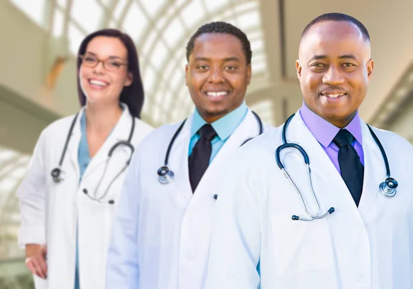 Female and Male Caucasian and African American Doctors in Hospit Royalty Free Stock Images