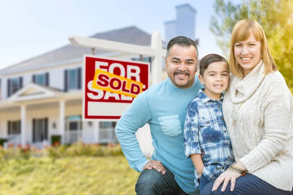 Mixed Race Family In front of House and Sold For Sale Real Estate Sign — стоковое фото