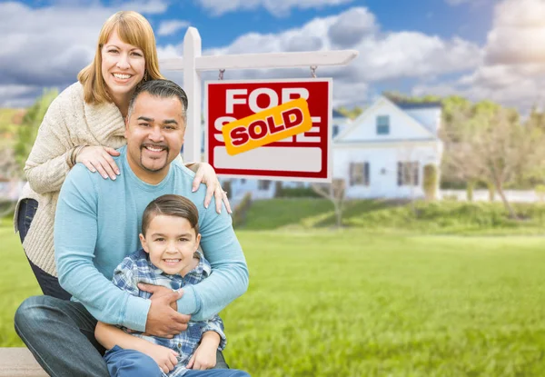 Mixed Race Family In front of House and Sold For Sale Real Estate Sign — стоковое фото