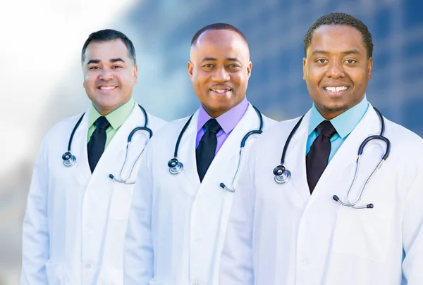 African American and Hispanic Male Doctors Outside of Hospital B Stock Photo
