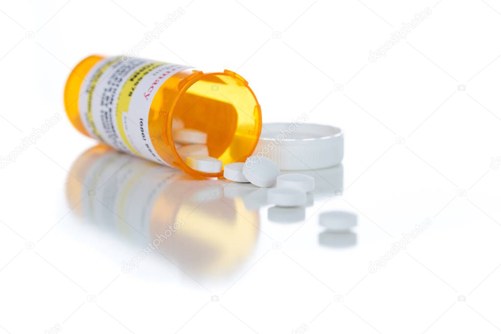 Non-Proprietary Medicine Prescription Bottle and Spilled Pills Isolated on White