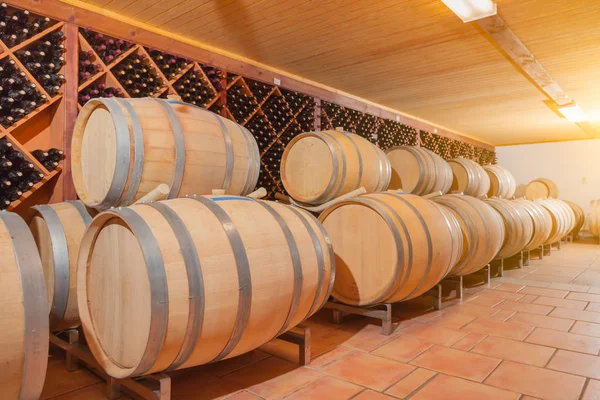 Wine Barrels and Bottles Age Inside Cellar — Stock Photo, Image