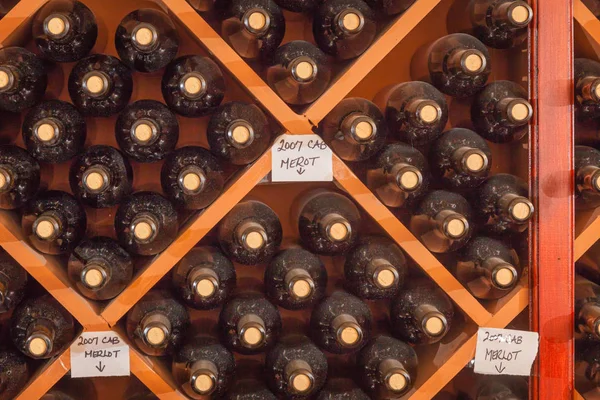 Varias botellas de vino varietal Edad dentro de la bodega — Foto de Stock