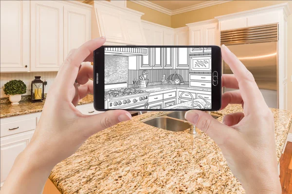 Hands Holding Smart Phone Displaying Drawing of Kitchen Photo Behind — Stock Photo, Image