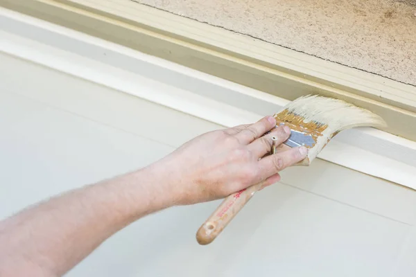 Pintor profesional que corta adentro con el cepillo para pintar el marco de la puerta del garaje — Foto de Stock