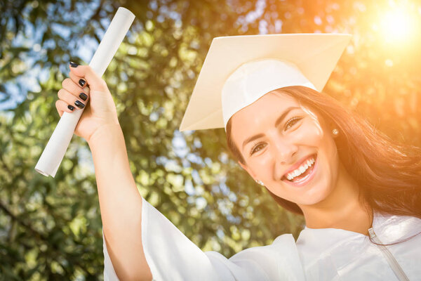 Graduating Mixed Race Girl In Cap and Gown with Diploma