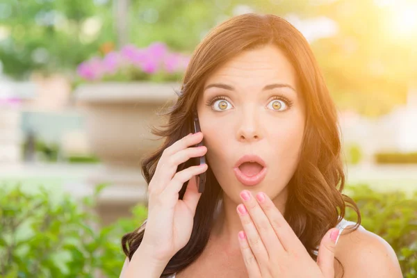 Shocked Young Adult Female Talking on Cell Phone Outdoors — Stock Photo, Image