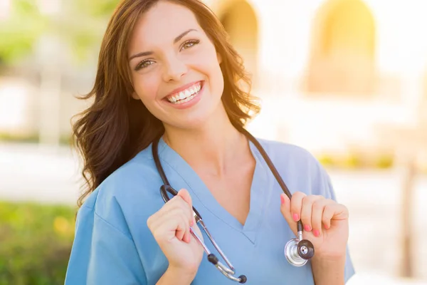 Mujer joven adulta Doctor o enfermera sosteniendo la almohadilla táctil afuera . —  Fotos de Stock