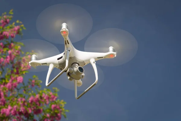 Unmanned Aircraft System (UAV) Quadcopter Drone In The Air.