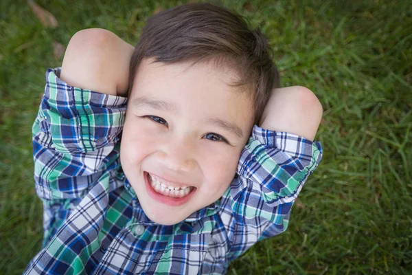 Mixed Race Chinese and Caucasian Young Boy Relaxing On His Back — Stock Photo, Image