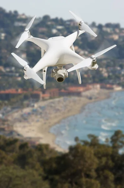 Unmanned Aircraft System (UAV) Quadcopter Drone In The Air Over The Ocean Coastline. — Stock Photo, Image