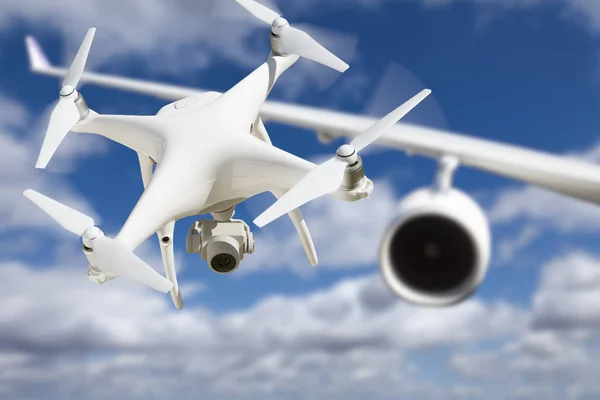 Unmanned Aircraft System (UAV) Quadcopter Drone In The Air Too Close To Passenger Airplane. — Stock Photo, Image