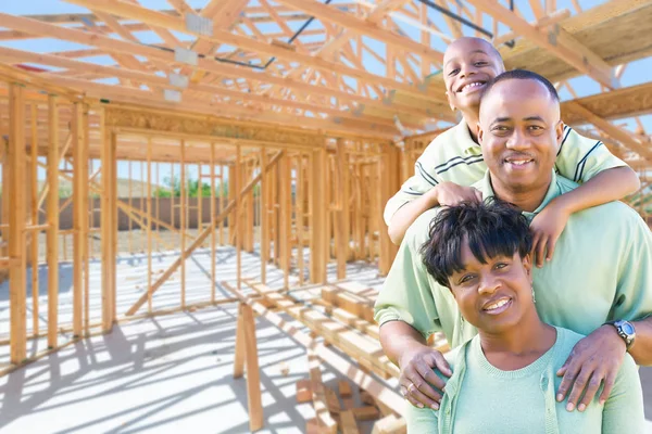 Νεαρή αφρικανική αμερικανική οικογένεια στην ιστοσελίδα στο εσωτερικό τους νέα εγχώρια κατασκευή πλαισιώνοντας. — Φωτογραφία Αρχείου