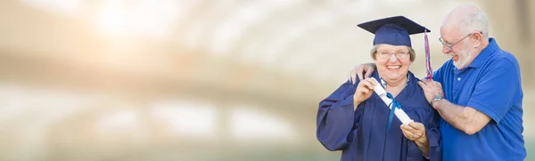 Banner of Senior Adult Woman Graduate In Cap and Gown Being Cong — Stock Photo, Image