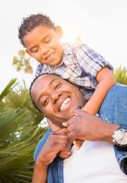 Mixed Race Son and African American Father Playing Piggyback Outdoors Together. — Stock Photo, Image