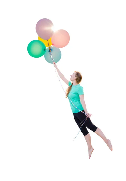 Joven chica siendo llevada arriba y lejos por globos que ella está sosteniendo aislado en un fondo blanco . — Foto de Stock