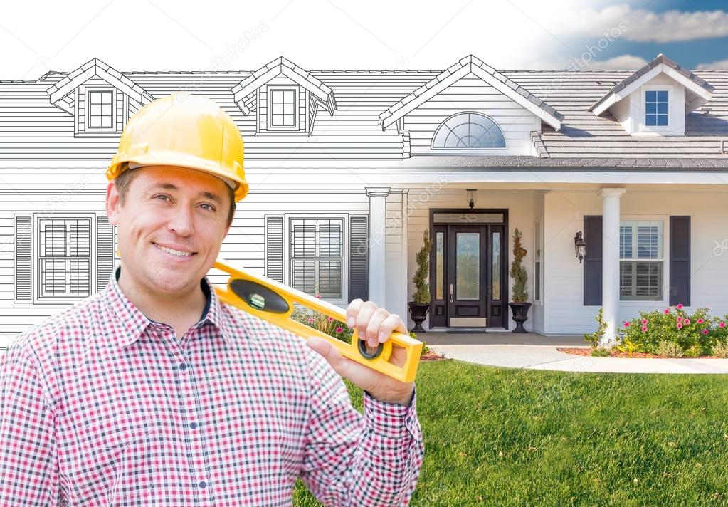 Male Contractor Wearing Hard Hat In Front of House Drawing Gradation Into Photograph.