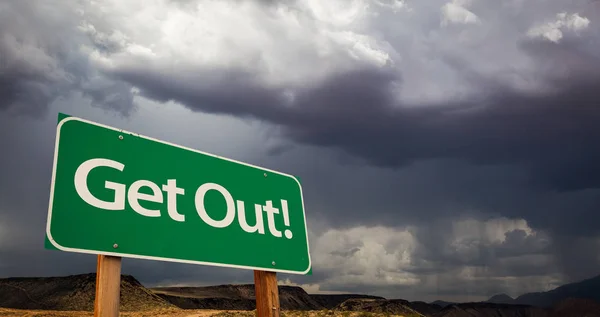 Get Out Green Road Sign and Stormy Clouds — Stock Photo, Image