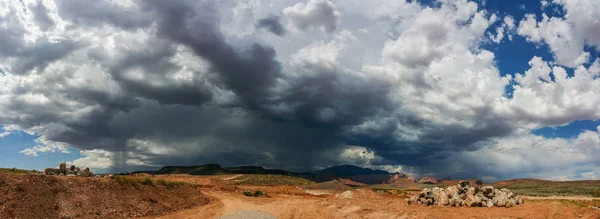 Ominous Stormy Sky and Cumulus Clouds with Rain Pano in the Desert.
