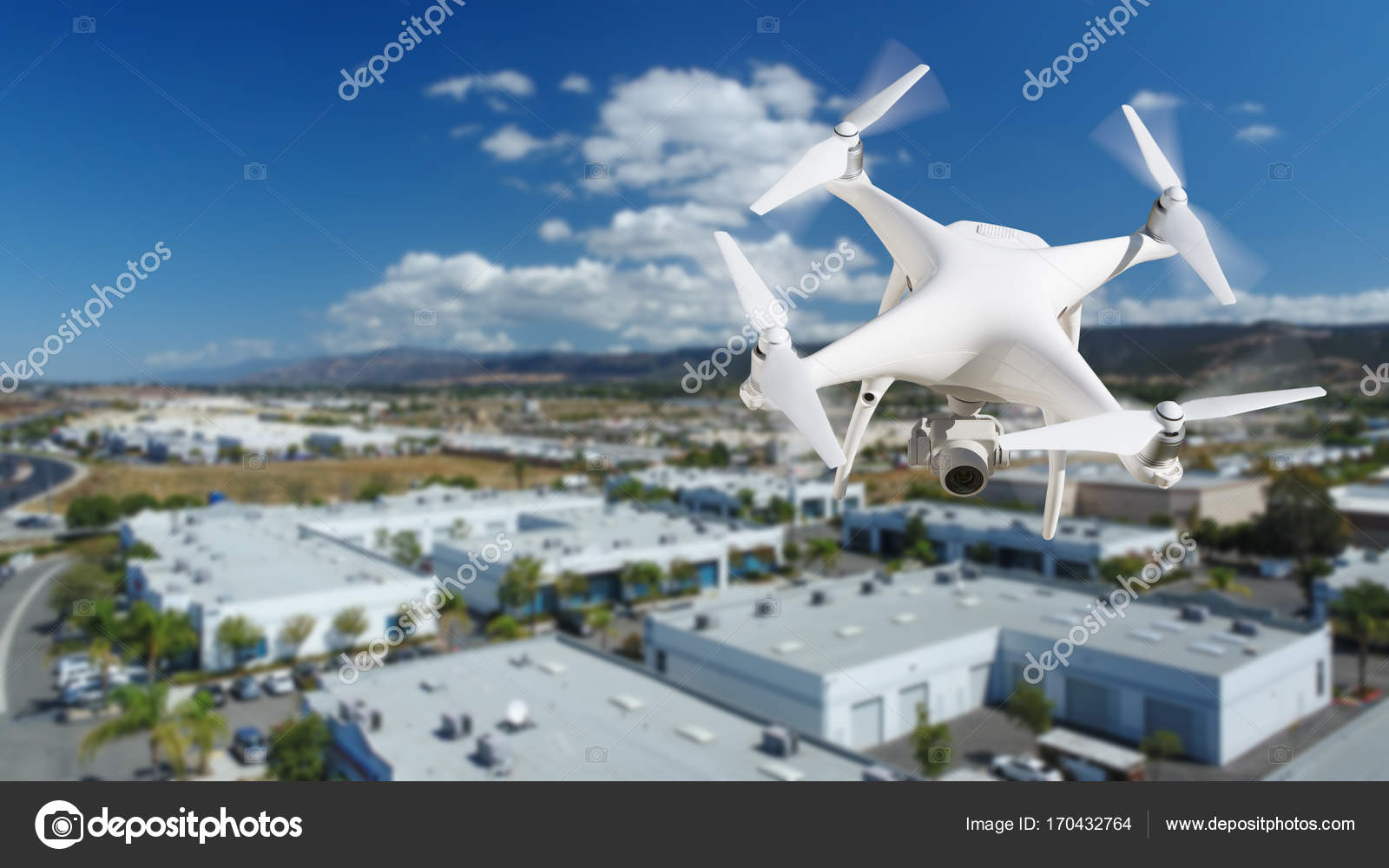 Unmanned Aircraft System (UAV) Quadcopter Drone In The Air Over Stock Photo by ©Feverpitch 170432764