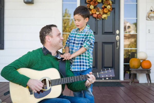 Young Mixed Race Chinese and Caucasian Son Singing Songs and Playing Guitar with Father — Stock Photo, Image