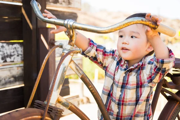 Blandad ras kaukasiska och kinesiska ung pojke att ha roligt på cykeln. — Stockfoto