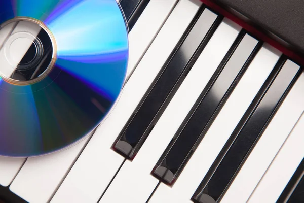 CD Laying on Piano Keyboard Abstrated — стоковое фото