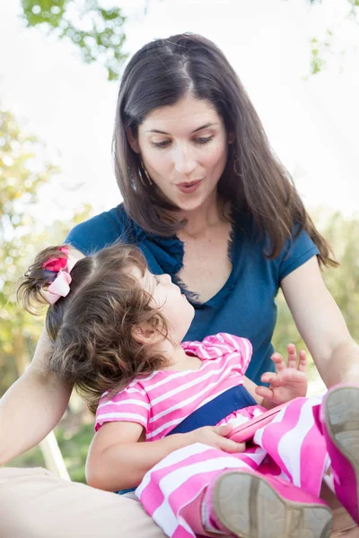 Mixed Race Mother and Cute Baby Daughter Playing with Cell Phone in Park. — Stock Photo, Image