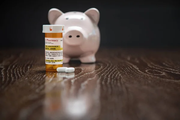 Non-Proprietary Prescription Medicine Bottle, Pills and Piggy Bank on Reflective Wooden Surface. — Stock Photo, Image