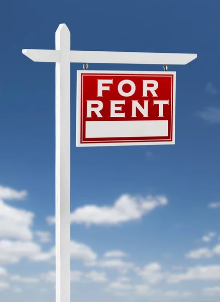 Right Facing for Rent Real Estate Sign on a Blue Sky with Clouds — стоковое фото