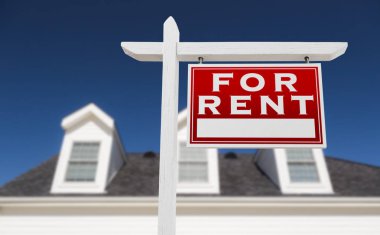 Right Facing For Rent Real Estate Sign In Front of House and Deep Blue Sky. clipart