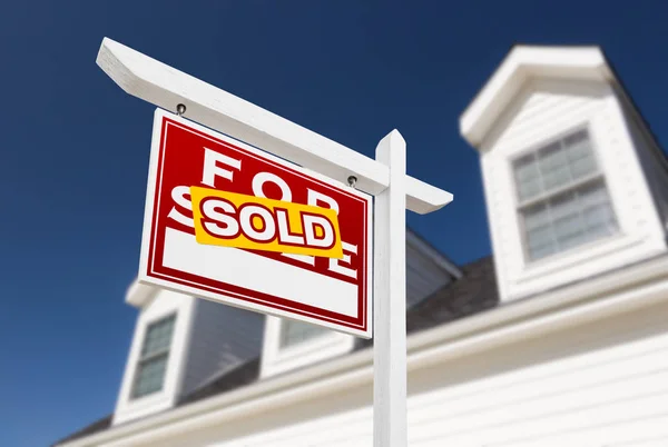 Left Facing Sold For Sale Real Estate Sign In Front of House and Deep Blue Sky. — Stock Photo, Image