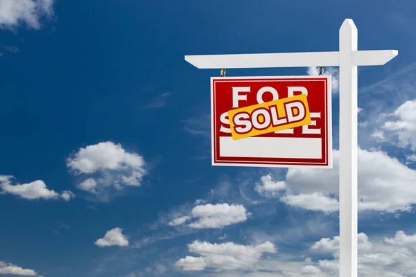 Left Facing Sold For Sale Real Estate Sign Over Blue Sky and Clouds With Room For Your Text. — Stock Photo, Image