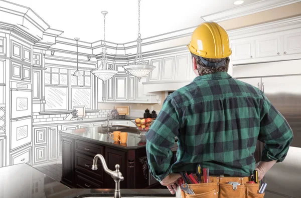 Male Contractor with Hard Hat and Tool Belt Looking At Custom Kitchen Drawing Photo Combination On White. — Stock Photo, Image