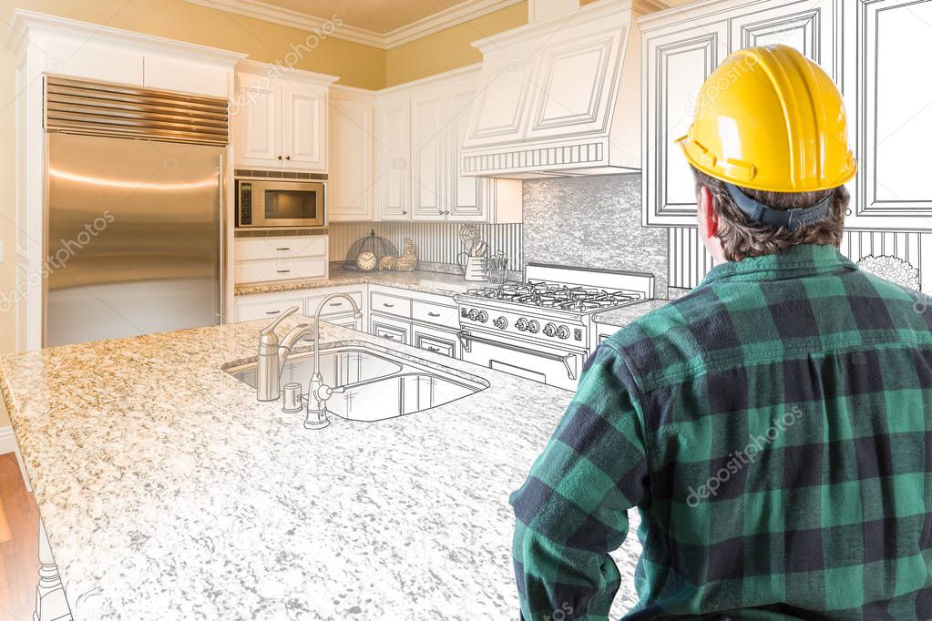 Male Contractor with Hard Hat Looking At Custom Kitchen Drawing Photo Combination On White.