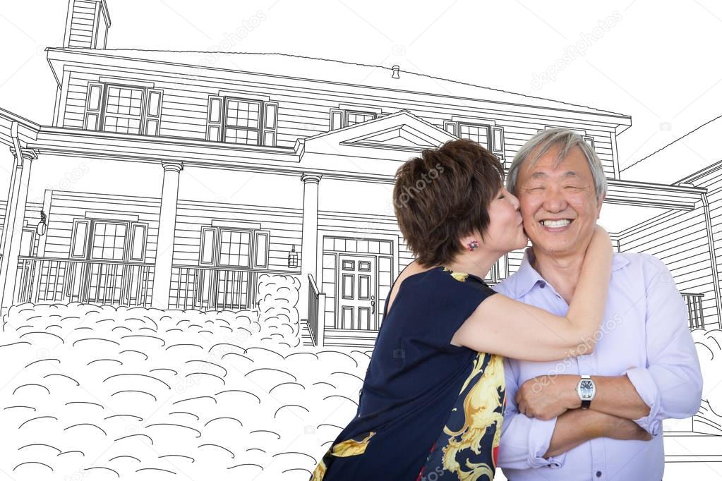 Chinese Senior Adult Couple Kissing In Front Of Custom House Drawing Plans.