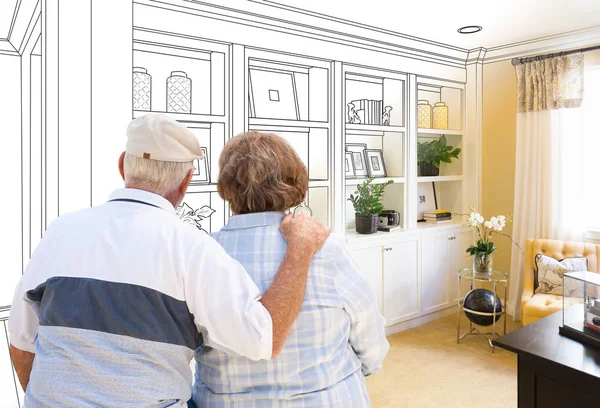 Senior Couple Facing Custom Built-in Shelves and Cabinets Design Drawing Gradating to Finished Photo. — Stock Photo, Image