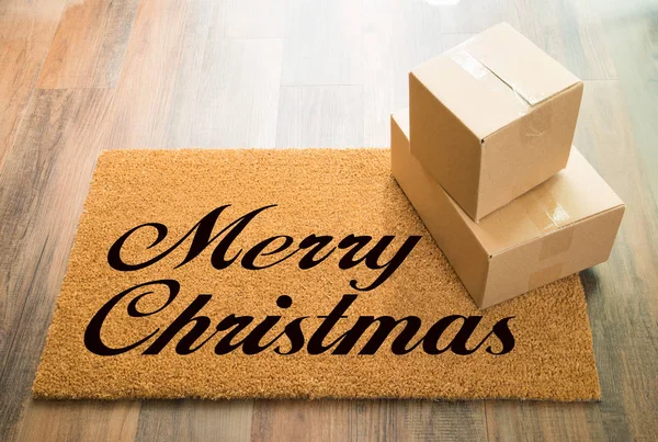 Frohe Weihnachten Willkommensmatte auf Holzboden mit Lieferung von Schachteln — Stockfoto