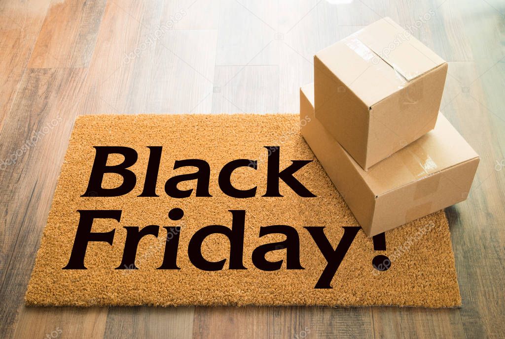 Black Friday Welcome Mat On Wood Floor With Shipment of Boxes