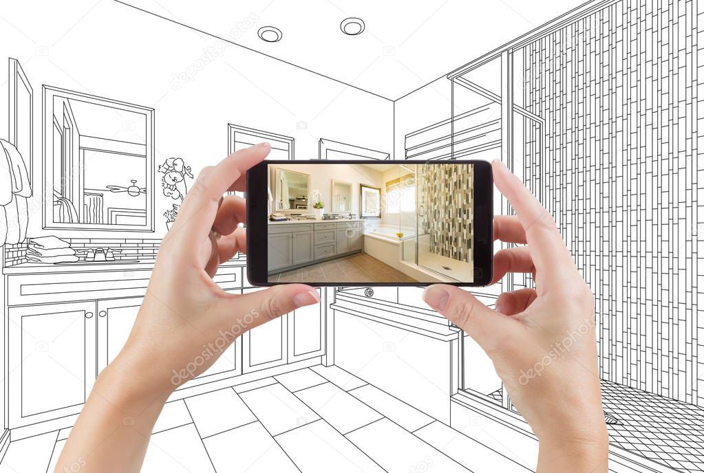 Hands Holding Smart Phone with Master Bathroom Photo on Screen and Drawing Behind.