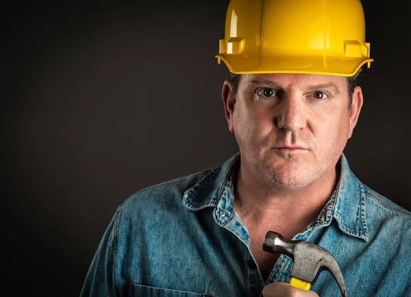 Serious Contractor in Hard Hat Holding Hammer With Dramatic Lighting. — Stock Photo, Image