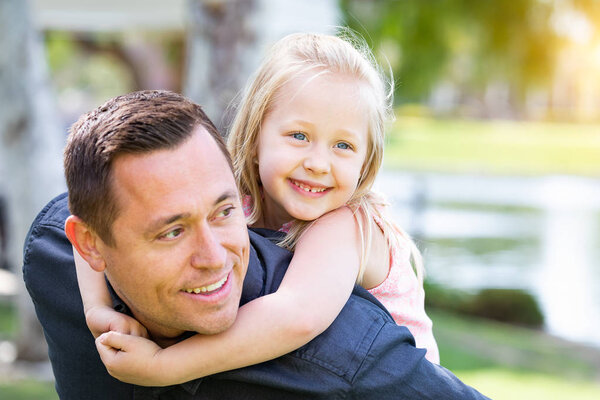 Young Caucasian Father and Daughter Having Fun At The Park