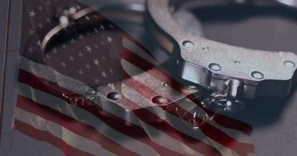 Handcuffs Rotation Closeup Ghosted American Flag Dark Background — Stock Video