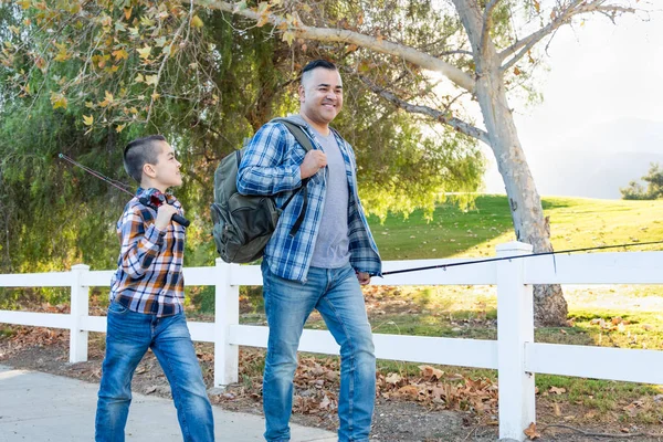 Mixed Race Father And Son Outdoors Walking With Fishing Poles — Stock Photo, Image