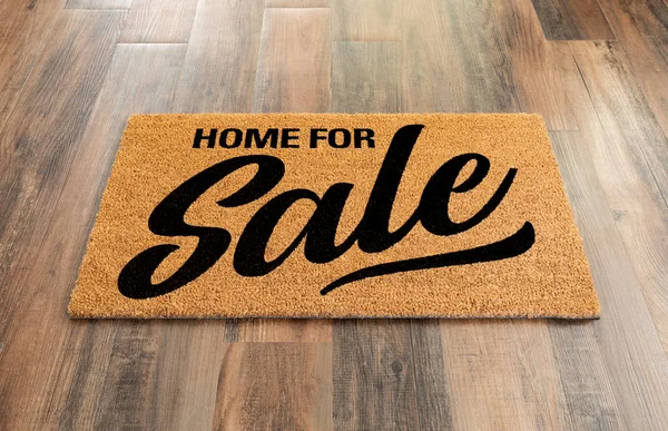 Home Na prodej Vítejte Mat na dřevěné podlaze na pozadí — Stock fotografie