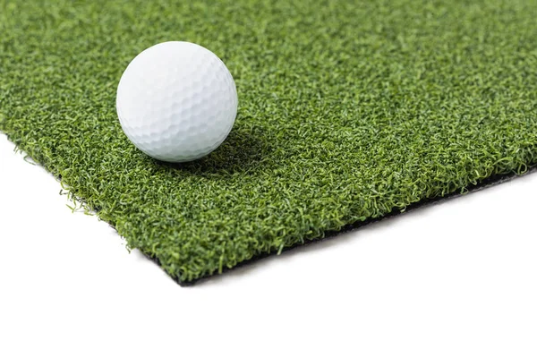 Golf Ball Resting on Section of Artificial Turf Grass On White Background — Stock Photo, Image