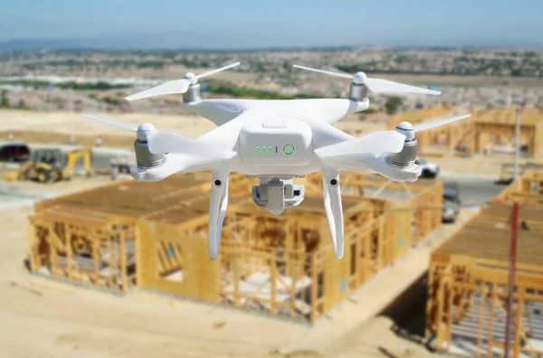 Unmanned Aircraft Quadcopter Drone Flying and Inspecting Construction Site