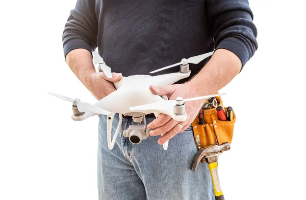 Construction Worker and Drone Pilot With Toolbelt Holding Quadcopter Drone Isolated on White Background — Stock Photo, Image