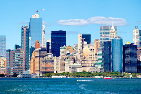 The Lower Manhattan skyline iand Battery Park n New York City seen from the ocean on a sunny summer day