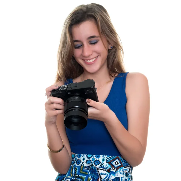 Pretty teenage girl looking at pictures on the rear display of a — Stock Photo, Image